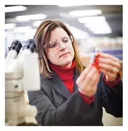Material scientist inspecting a valve component